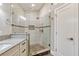 Bathroom featuring tile shower, glass door, vanity with granite countertop, and tiled floors at 8922 Bay Cove Ct, Orlando, FL 32819