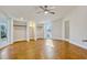 Bright bedroom featuring hardwood floors, windows, ceiling fan, and built-in closets at 8922 Bay Cove Ct, Orlando, FL 32819