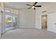 Bright bedroom with a neutral color scheme, carpet, and access to a private balcony at 8922 Bay Cove Ct, Orlando, FL 32819