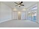 Bedroom featuring a ceiling fan, large windows, and double closets at 8922 Bay Cove Ct, Orlando, FL 32819
