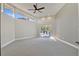 Bright bedroom with large windows, ceiling fan, and access to the outdoor terrace at 8922 Bay Cove Ct, Orlando, FL 32819