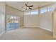 Bright bedroom with large windows, ceiling fan, and access to the outdoor terrace at 8922 Bay Cove Ct, Orlando, FL 32819