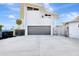 Modern two-story home with a gray garage door and a spacious driveway, showcasing contemporary architecture at 8922 Bay Cove Ct, Orlando, FL 32819
