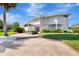 Striking view of a modern two-story home, showcasing its unique architectural design and beautifully maintained front yard at 8922 Bay Cove Ct, Orlando, FL 32819