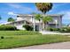 Beautiful home with a modern design, complemented by a meticulously maintained lawn, lush tropical landscaping, and a welcoming driveway at 8922 Bay Cove Ct, Orlando, FL 32819
