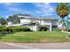 Eye-catching view of the unique home featuring lush landscaping, a well-manicured lawn, and a distinct architectural style at 8922 Bay Cove Ct, Orlando, FL 32819