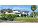This home features a modern design, well-maintained landscaping, a lush green lawn, and a unique architectural style at 8922 Bay Cove Ct, Orlando, FL 32819