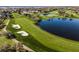 Aerial view of lush green golf course with pristine fairways, sand bunkers, and tranquil ponds at 8922 Bay Cove Ct, Orlando, FL 32819