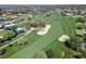 Aerial image showcases a golf course and event grounds, featuring manicured lawns, sand traps, and mature trees at 8922 Bay Cove Ct, Orlando, FL 32819