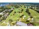Aerial image showcasing a sprawling golf course community with multiple greens, sand traps, and residential homes at 8922 Bay Cove Ct, Orlando, FL 32819