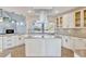 Gourmet kitchen with a center island, stainless steel hood, and a large window showcasing the backyard at 8922 Bay Cove Ct, Orlando, FL 32819