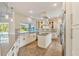 Modern kitchen with stainless steel appliances, center island, tile backsplash, and large window overlooking the backyard at 8922 Bay Cove Ct, Orlando, FL 32819