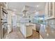 Updated kitchen featuring a center island, stainless steel appliances, and a view of the outdoor patio at 8922 Bay Cove Ct, Orlando, FL 32819