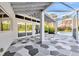 Expansive screened lanai overlooking the pool, featuring geometric flooring and access through sliding glass doors at 8922 Bay Cove Ct, Orlando, FL 32819