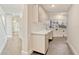 Spacious laundry room featuring sleek cabinetry, sink, and tile flooring at 8922 Bay Cove Ct, Orlando, FL 32819