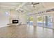 Spacious living room featuring a fireplace, vaulted ceiling, and sliding glass doors to the backyard at 8922 Bay Cove Ct, Orlando, FL 32819