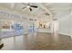 Large open-concept living room featuring tile floors, beamed ceiling, kitchen, and access to the pool area at 8922 Bay Cove Ct, Orlando, FL 32819