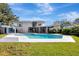 Beautiful backyard featuring a pool, lanai, and pool house, perfect for outdoor relaxation and entertainment at 8922 Bay Cove Ct, Orlando, FL 32819