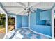 Inviting pool house with blue walls, unique geometric flooring, and convenient wet bar for entertaining at 8922 Bay Cove Ct, Orlando, FL 32819