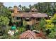Luxury estate home with multiple towers, a pool, and extensive landscaping at 9291 Point Cypress Dr, Orlando, FL 32836