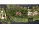 Breathtaking aerial view of the home nestled among mature trees on a private island at 9291 Point Cypress Dr, Orlando, FL 32836