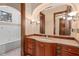 Elegant bathroom with a luxurious soaking tub, custom vanity, and decorative lighting fixtures at 9291 Point Cypress Dr, Orlando, FL 32836