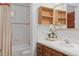 Clean bathroom featuring a white tiled shower, a wood vanity, and modern fixtures at 9291 Point Cypress Dr, Orlando, FL 32836