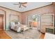 Bright bedroom featuring a wrought iron bed frame, balcony access, and unique wall paint at 9291 Point Cypress Dr, Orlando, FL 32836