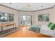 Bedroom with windows, wood floors, ceiling fan and views of trees and foliage at 9291 Point Cypress Dr, Orlando, FL 32836