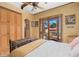 Bedroom featuring an ornate headboard, balcony access, decorative trim and neutral tones at 9291 Point Cypress Dr, Orlando, FL 32836