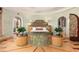 Ornate bedroom with round design, curved windows, and a unique carved wood bed frame at 9291 Point Cypress Dr, Orlando, FL 32836