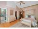 Charming bedroom with light pink walls, a bed, and a door leading to a bathroom at 9291 Point Cypress Dr, Orlando, FL 32836