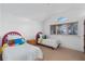 Bright bedroom with twin beds, cozy decor, and a large window with natural light at 9291 Point Cypress Dr, Orlando, FL 32836