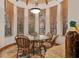 Breakfast nook with glass table, four chairs and views of the surrounding property at 9291 Point Cypress Dr, Orlando, FL 32836