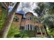 Unique turret-style home exterior featuring a private balcony and lush greenery at 9291 Point Cypress Dr, Orlando, FL 32836
