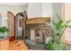 Interior shot of a decorated fireplace featuring carvings and a tropical plant at 9291 Point Cypress Dr, Orlando, FL 32836
