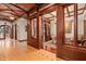Grand foyer with elaborate wood trim and finishes leading into an office with custom millwork at 9291 Point Cypress Dr, Orlando, FL 32836