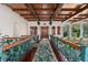 Ornate foyer with wood ceilings and beams, a decorative railing, and view to the outside at 9291 Point Cypress Dr, Orlando, FL 32836