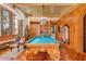 Unique game room featuring a pool table with carved elephant legs and custom woodwork at 9291 Point Cypress Dr, Orlando, FL 32836