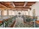 Hallway with decorative railings, patterned rug, decorative chandelier and wood-beamed ceilings at 9291 Point Cypress Dr, Orlando, FL 32836