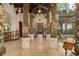 Impressive hallway with ornate columns, tile flooring, and a view into the library at 9291 Point Cypress Dr, Orlando, FL 32836