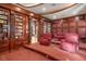 Comfortable home theater with plush seating, tiered platform, and built-in bookshelves for movie storage at 9291 Point Cypress Dr, Orlando, FL 32836