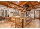 Gourmet kitchen boasts custom wood cabinets, large center island with cooktop, and counter seating at 9291 Point Cypress Dr, Orlando, FL 32836