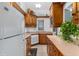 Charming kitchen featuring wooden cabinets, tile countertops, modern appliances, and bright natural light at 9291 Point Cypress Dr, Orlando, FL 32836