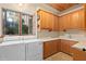 A practical laundry room provides ample storage, countertop space, and natural light at 9291 Point Cypress Dr, Orlando, FL 32836