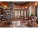 Stately library with a spiral staircase, built-in bookshelves, and cozy seating area at 9291 Point Cypress Dr, Orlando, FL 32836