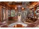 Spacious library featuring a spiral staircase, floor-to-ceiling bookshelves, and reading nook at 9291 Point Cypress Dr, Orlando, FL 32836