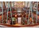 Dramatic view of a spiral staircase and custom bookcases in a wood-clad library at 9291 Point Cypress Dr, Orlando, FL 32836