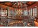 Second floor view of library with custom wrought iron railing, bookshelves, and chandelier at 9291 Point Cypress Dr, Orlando, FL 32836