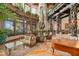 Unique living room featuring a piano, fireplace, ornately decorated beams and columns and large windows at 9291 Point Cypress Dr, Orlando, FL 32836